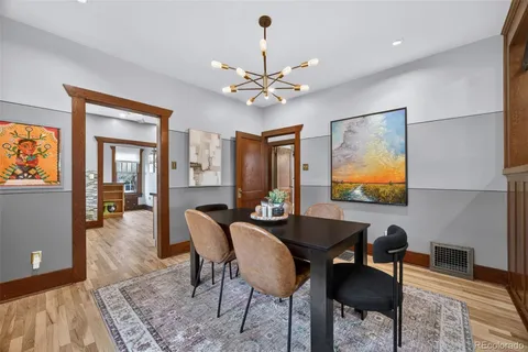 a dining room with furniture a rug and a chandelier