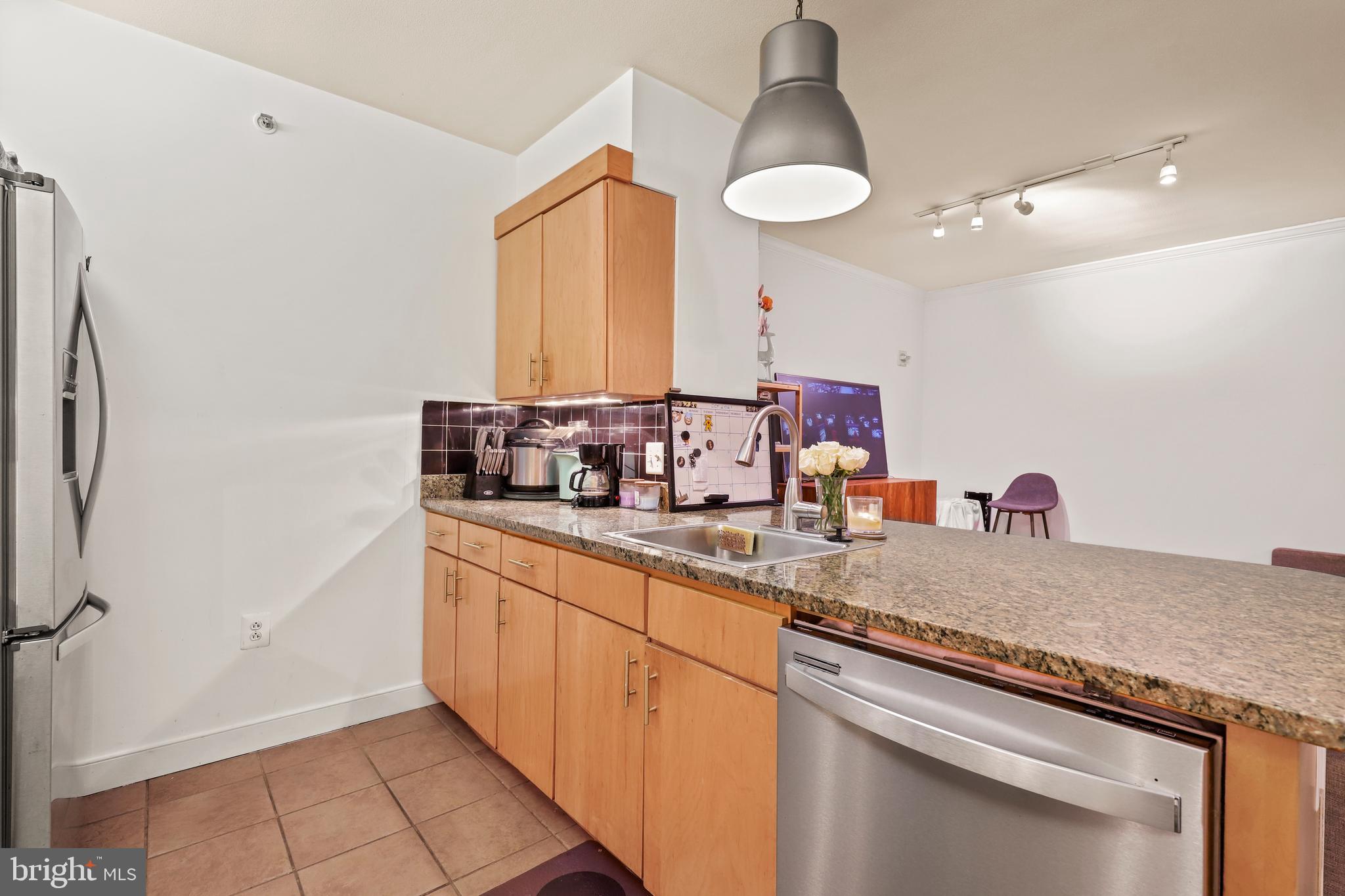 616 E Street Northwest, Unit 1007 Washington, DC 20004 - Photo 32 of 99 a kitchen with a sink and a refrigerator