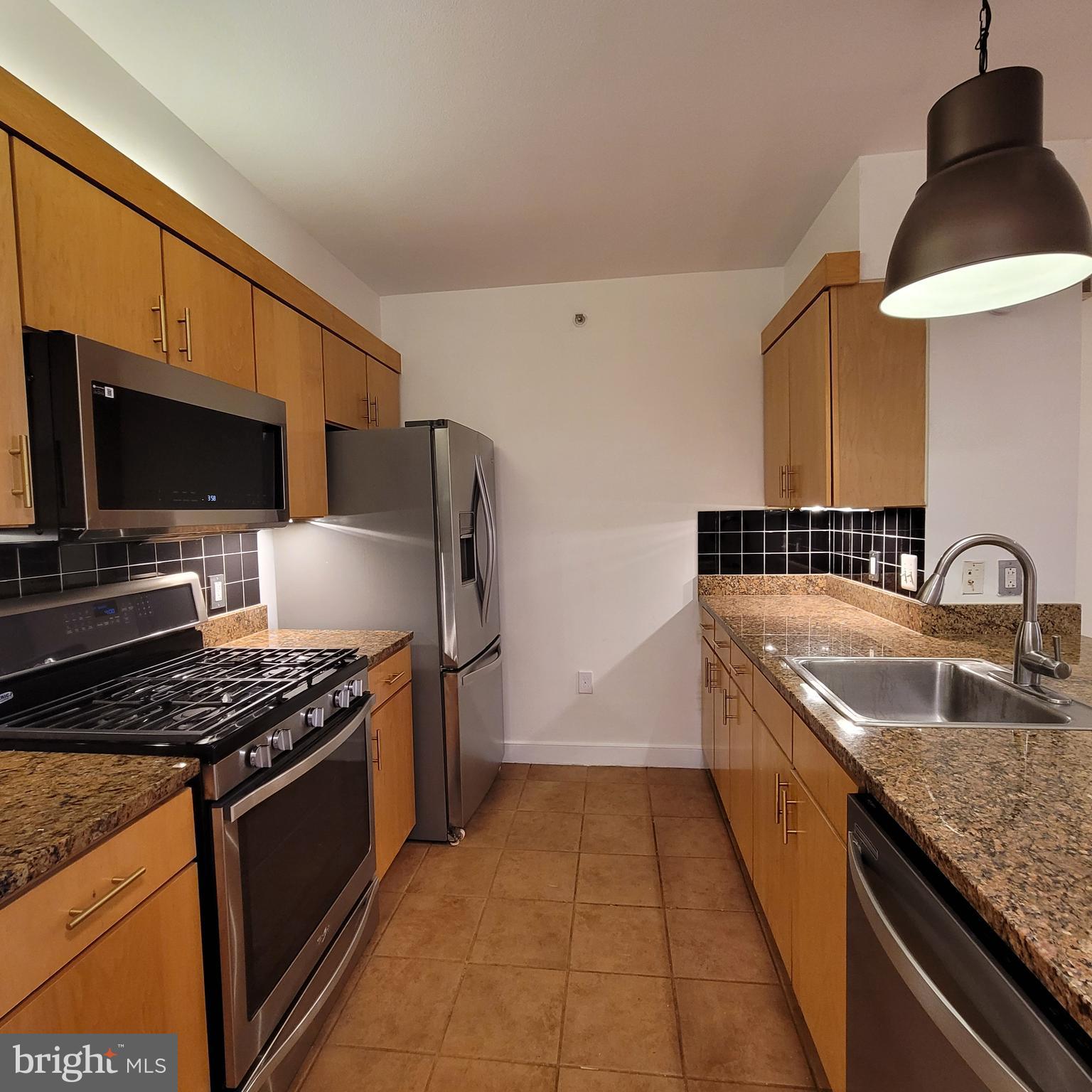 616 E Street Northwest, Unit 1007 Washington, DC 20004 - Photo 7 of 99 a kitchen with stainless steel appliances granite countertop a sink stove and refrigerator