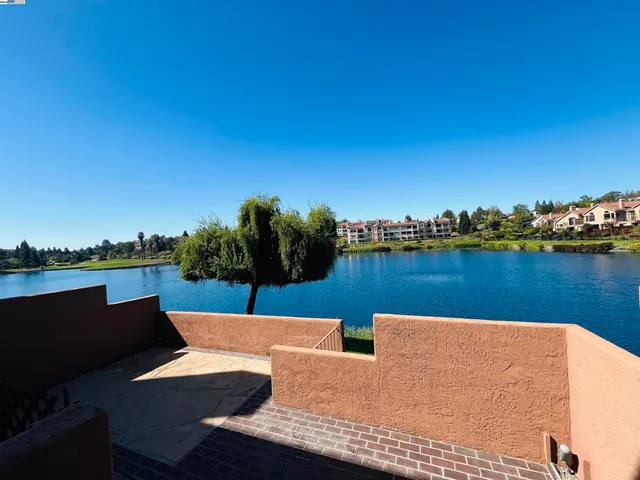 a view of a lake with houses in the back
