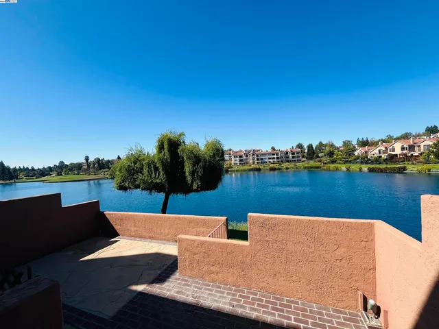 a view of a lake with houses in the back