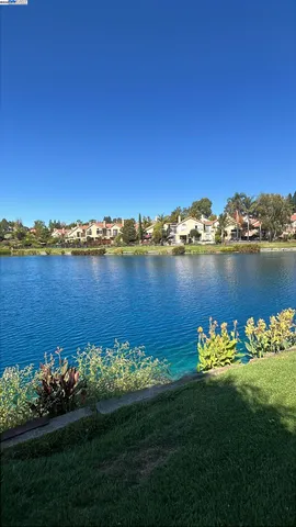 an aerial view of a houses with yard swimming pool and outdoor seating