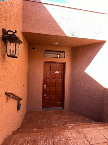 a view of a swimming pool with a garden and mountain view in back