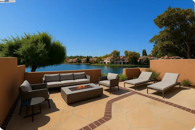 a terrace with outdoor seating and trees