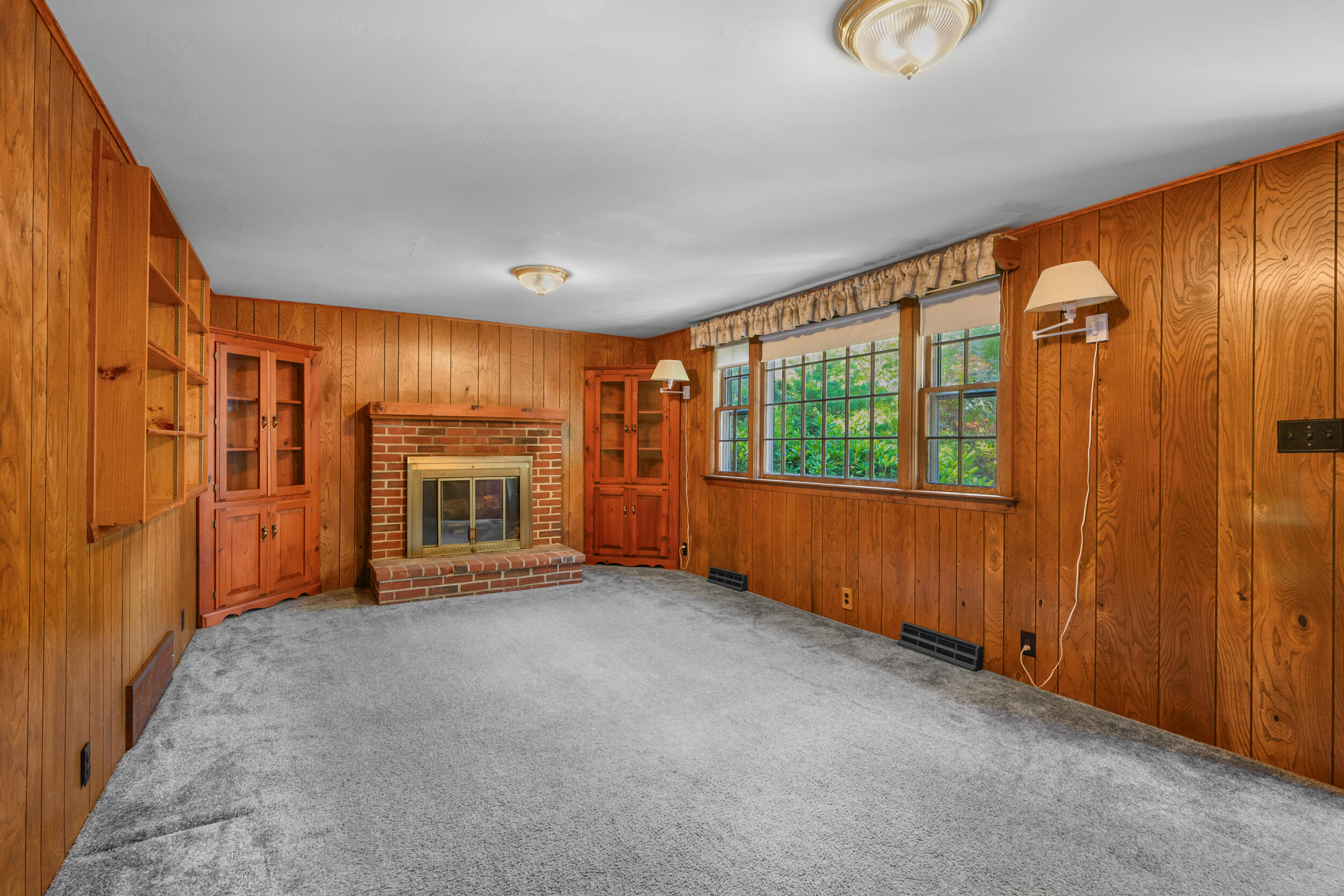 10 Mc Guerty Road Eastham, MA 02642 - Photo 14 of 39 an empty room with windows fire place and a window