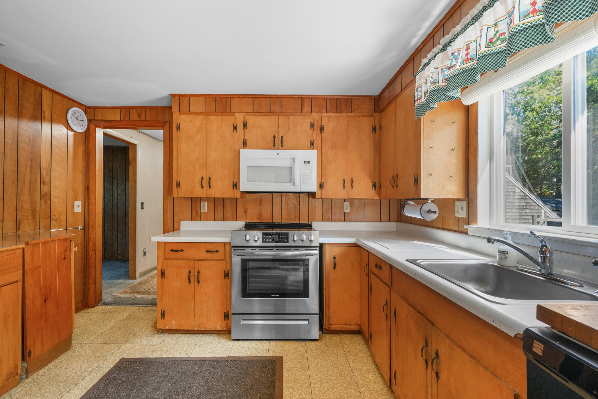 10 Mc Guerty Road Eastham, MA 02642 - Photo 9 of 39 a kitchen with stainless steel appliances granite countertop a sink a stove and a refrigerator