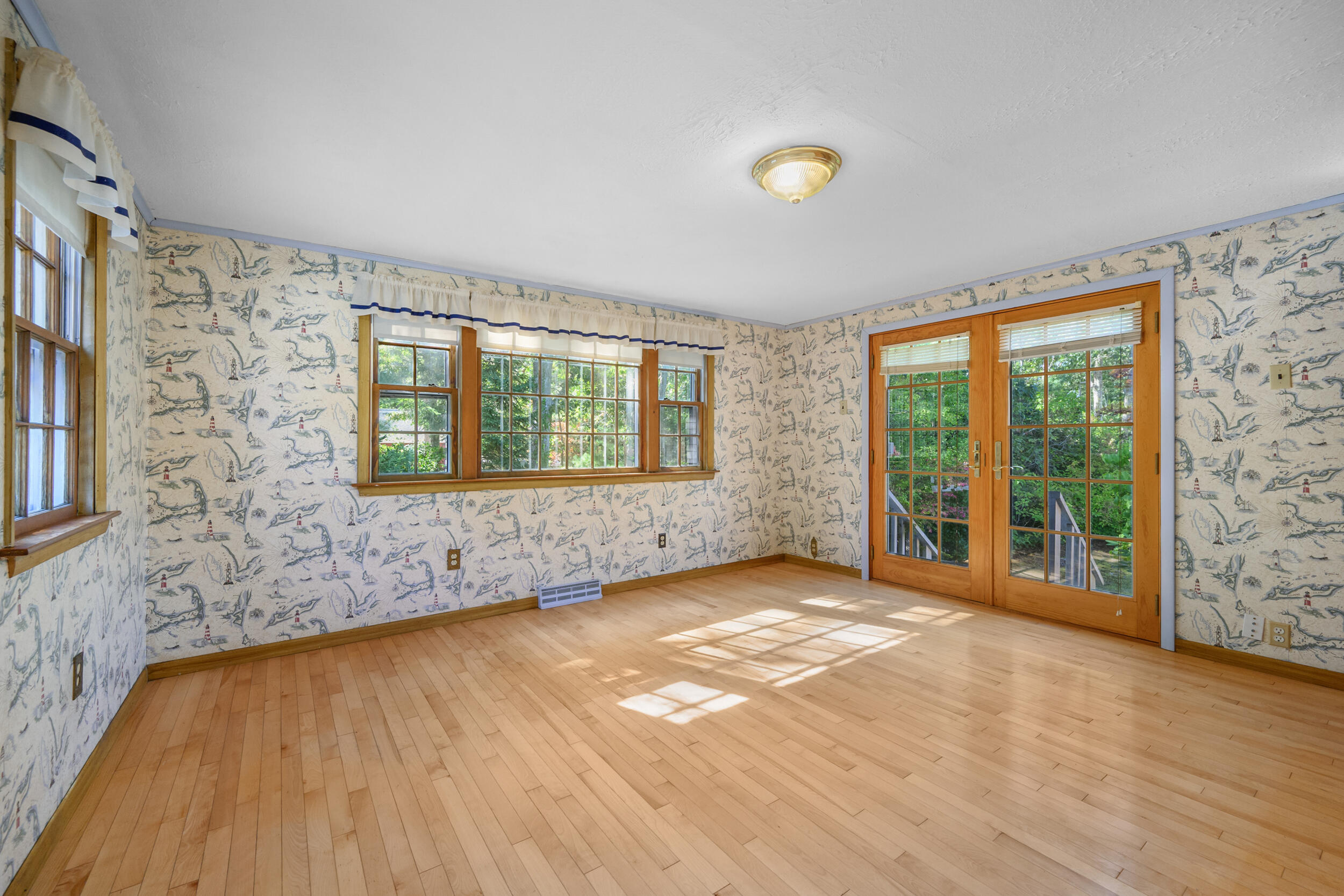 10 Mc Guerty Road Eastham, MA 02642 - Photo 10 of 39 a view of an empty room with wooden floor and a window
