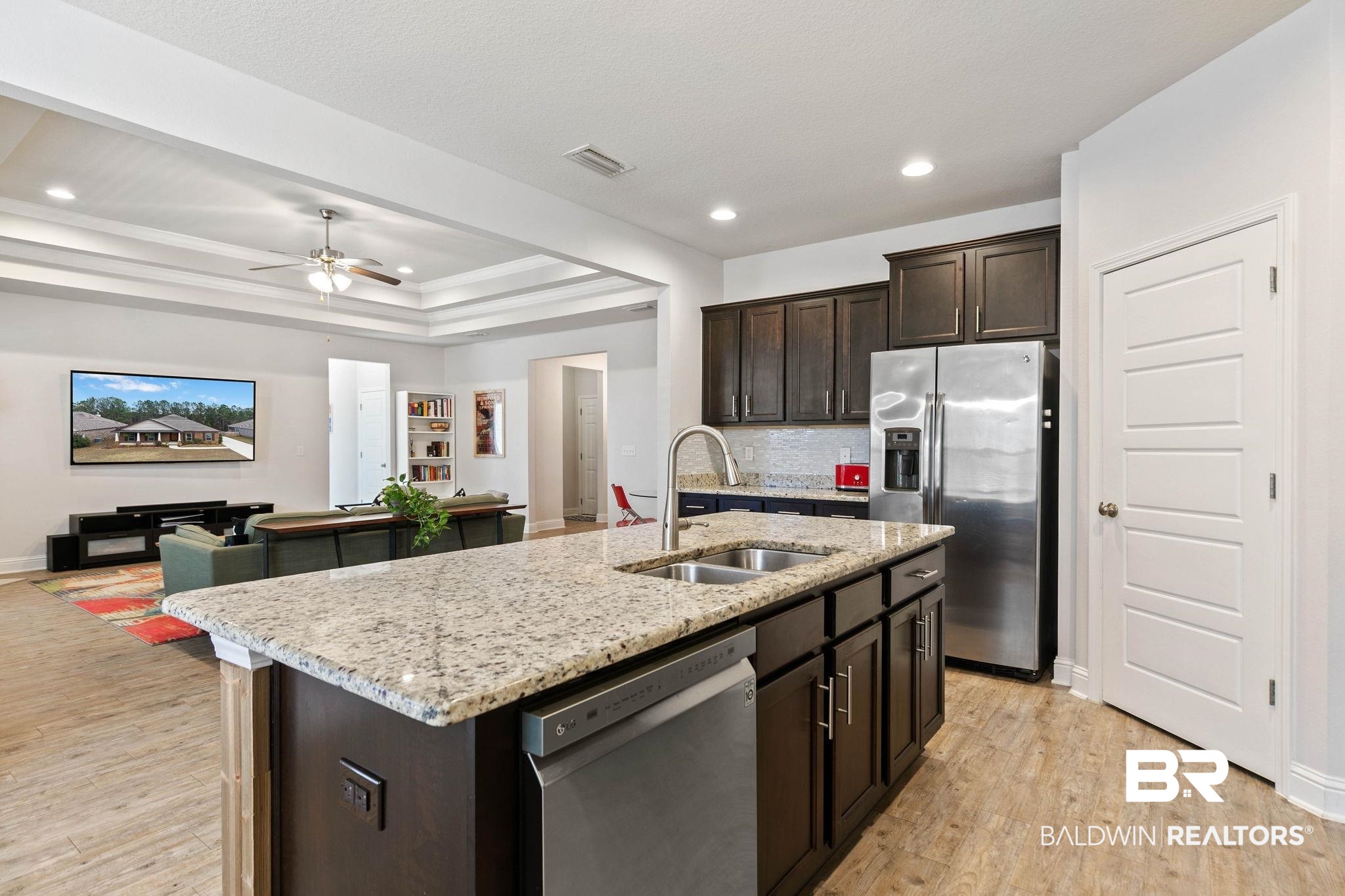 31350 Hoot Owl Road Daphne, AL 36527 - Photo 93 of 94 Kitchen featuring dark wood finish cabinetry, open floor plan, stainless steel appliances, light stone countertops, and ceiling fan
