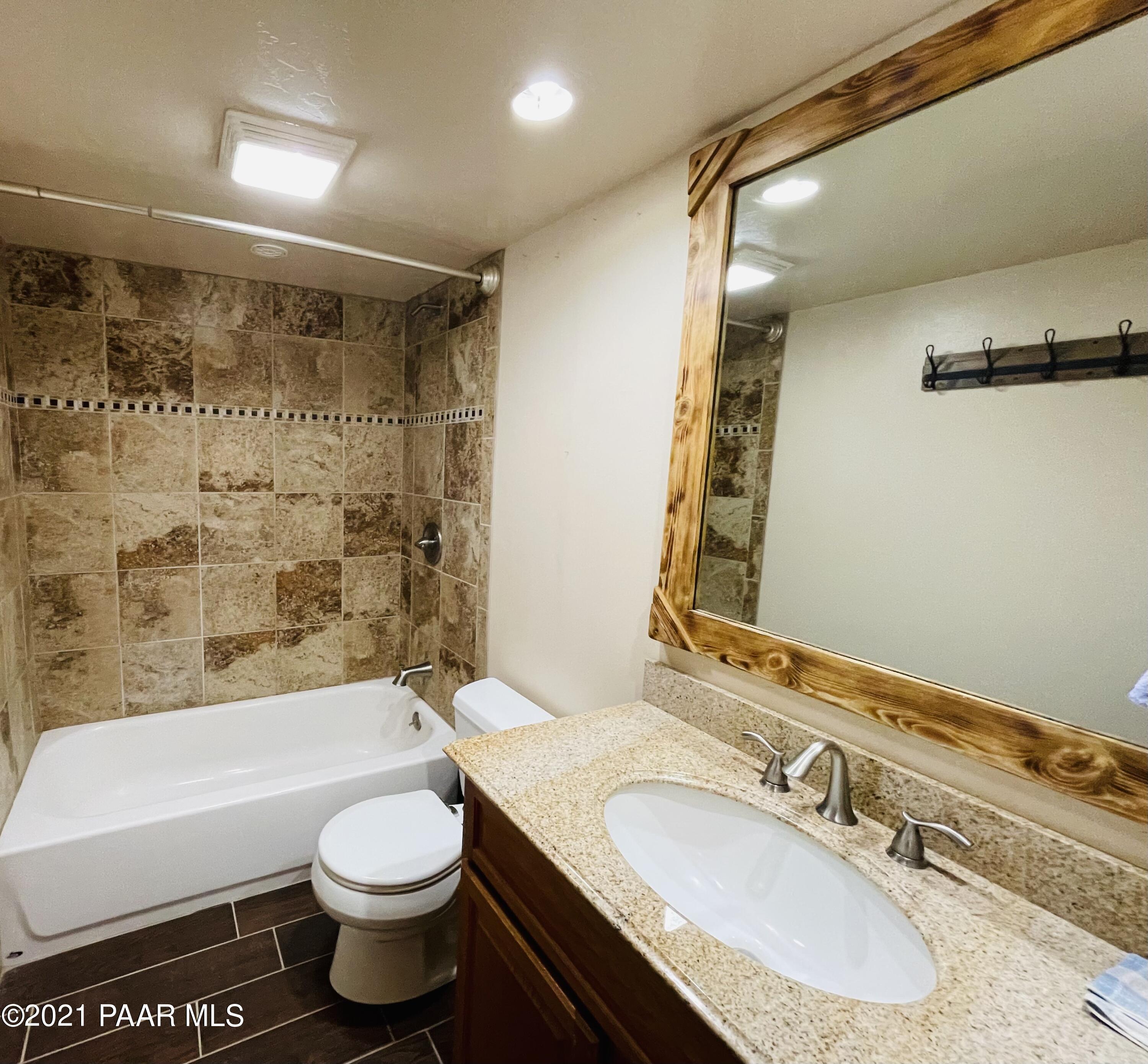 2895 North Reed Road Chino Valley, AZ 86323 - Photo 13 of 40 a bathroom with a granite countertop sink toilet and shower
