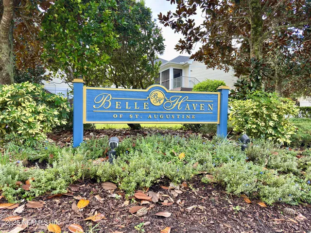 a sign broad in front of flowers