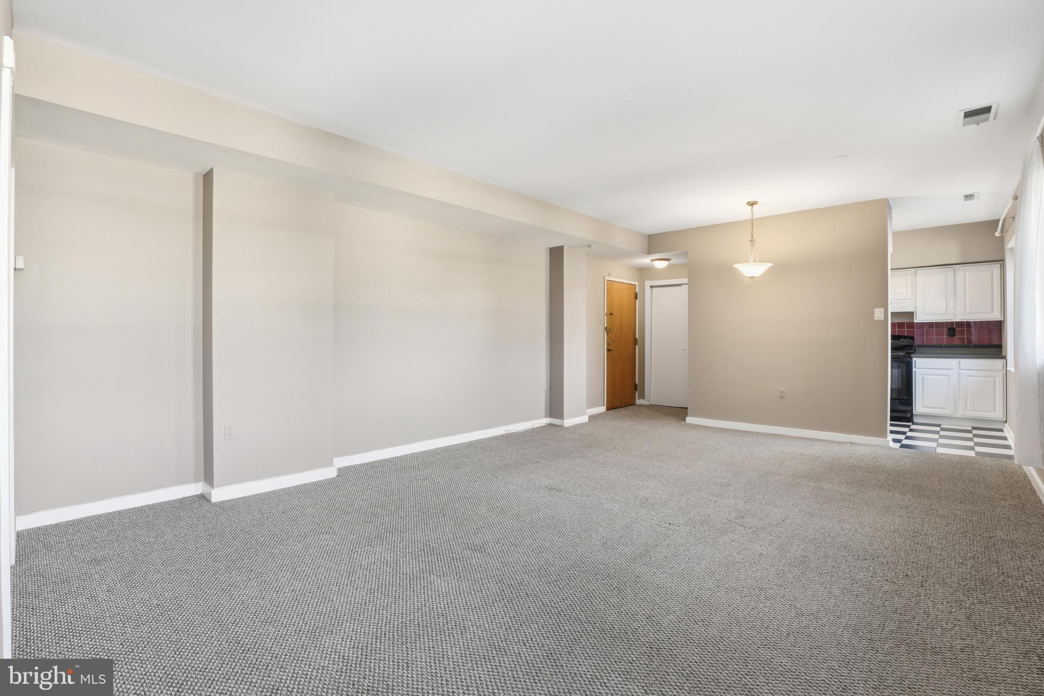 66 New York Avenue Northwest, Unit 403 Washington, DC 20001 - Photo 11 of 29 a view of an empty room with a kitchen
