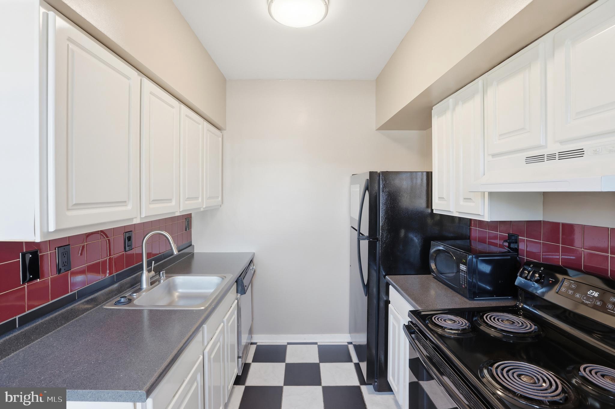 66 New York Avenue Northwest, Unit 403 Washington, DC 20001 - Photo 14 of 29 a kitchen with stainless steel appliances granite countertop a sink stove and refrigerator