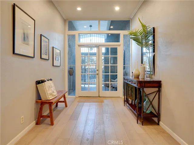 a view of a hallway with furniture and a window
