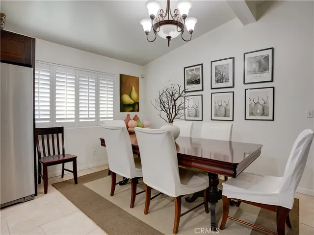 a view of a livingroom and a dining room with furniture window and wooden floor