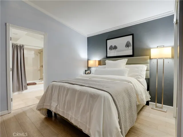 a bedroom with a bed and a lamp