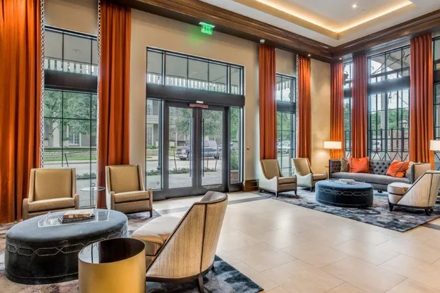 a living room with furniture and large windows