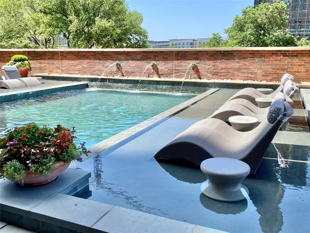 a view of a swimming pool with a bench and floor to ceiling window