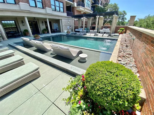 a view of a terrace with lawn chairs and potted plants