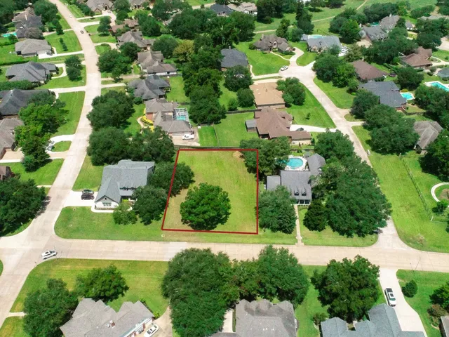 an aerial view of residential houses with outdoor space and street view
