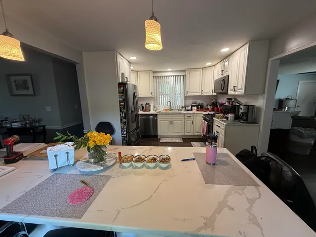 a kitchen with a sink appliances and cabinets