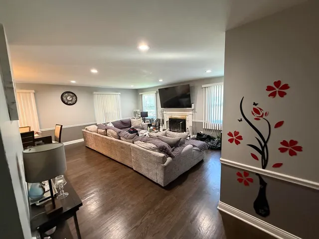 a living room with furniture and flat screen tv