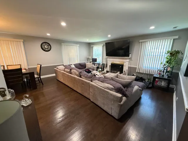 a living room with furniture fireplace and flat screen tv