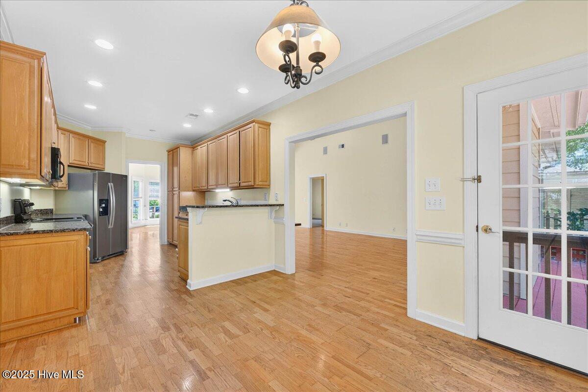 8985 Woodbine Road Southwest Sunset Beach, NC 28468 - Photo 20 of 65 Kitchen dining area and door to the back deck
