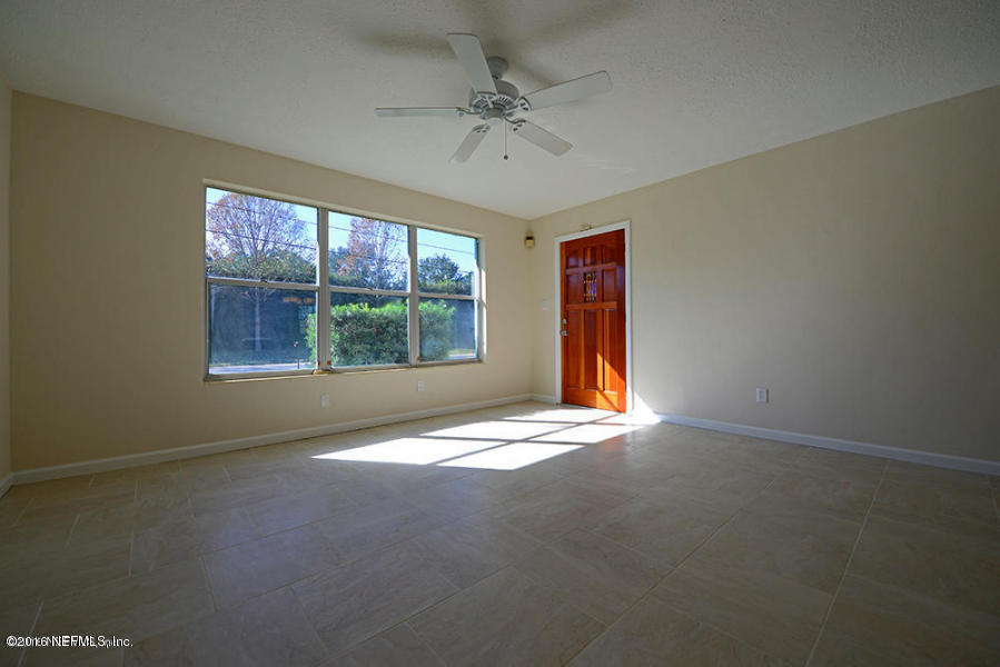 4527 Ruckner Road Jacksonville, FL 32207 - Photo 4 of 15 an empty room with windows and fan