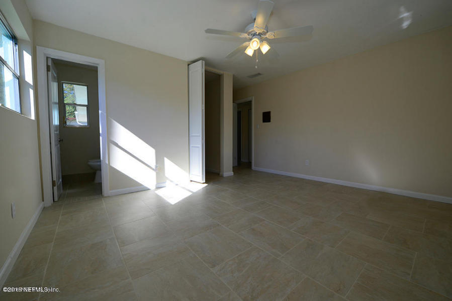 4527 Ruckner Road Jacksonville, FL 32207 - Photo 9 of 15 wooden floor in an empty room with a window