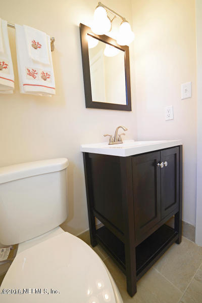 4527 Ruckner Road Jacksonville, FL 32207 - Photo 10 of 15 a bathroom with a toilet sink and mirror