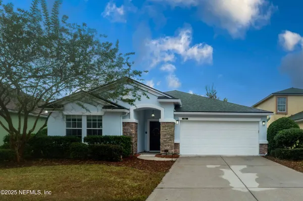 a front view of a house with a yard and garage