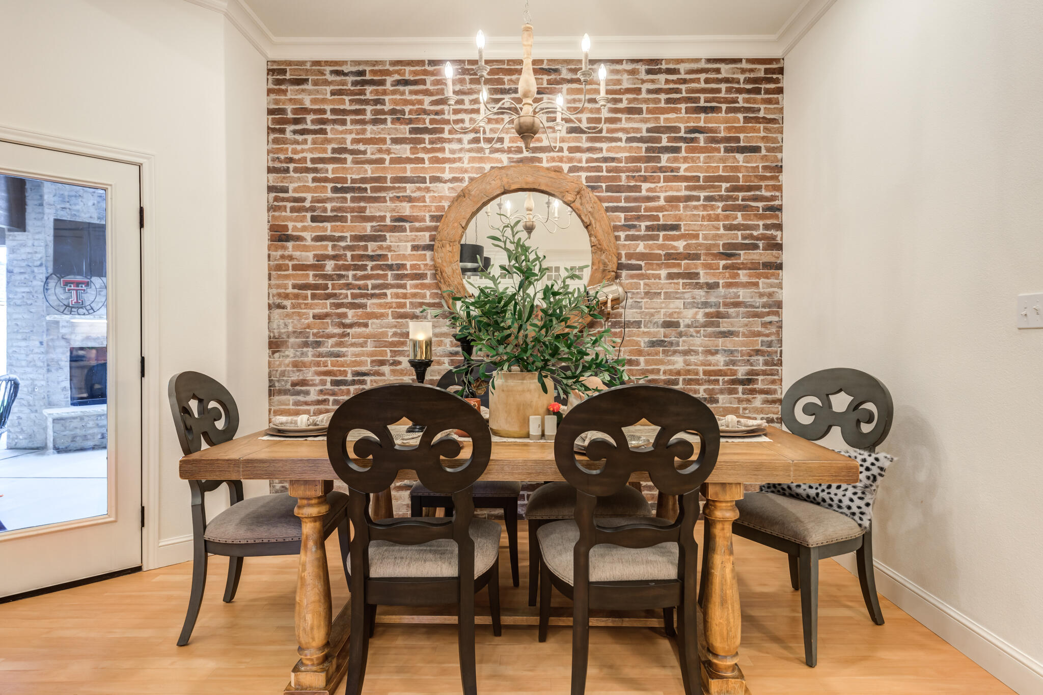 7819 55th Street Lubbock, TX 79407 - Photo 16 of 39 a table with chairs and a vase with flowers on it