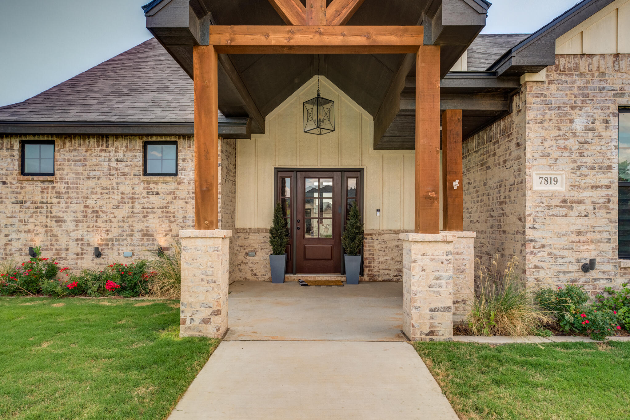7819 55th Street Lubbock, TX 79407 - Photo 2 of 39 a front view of a house with garden