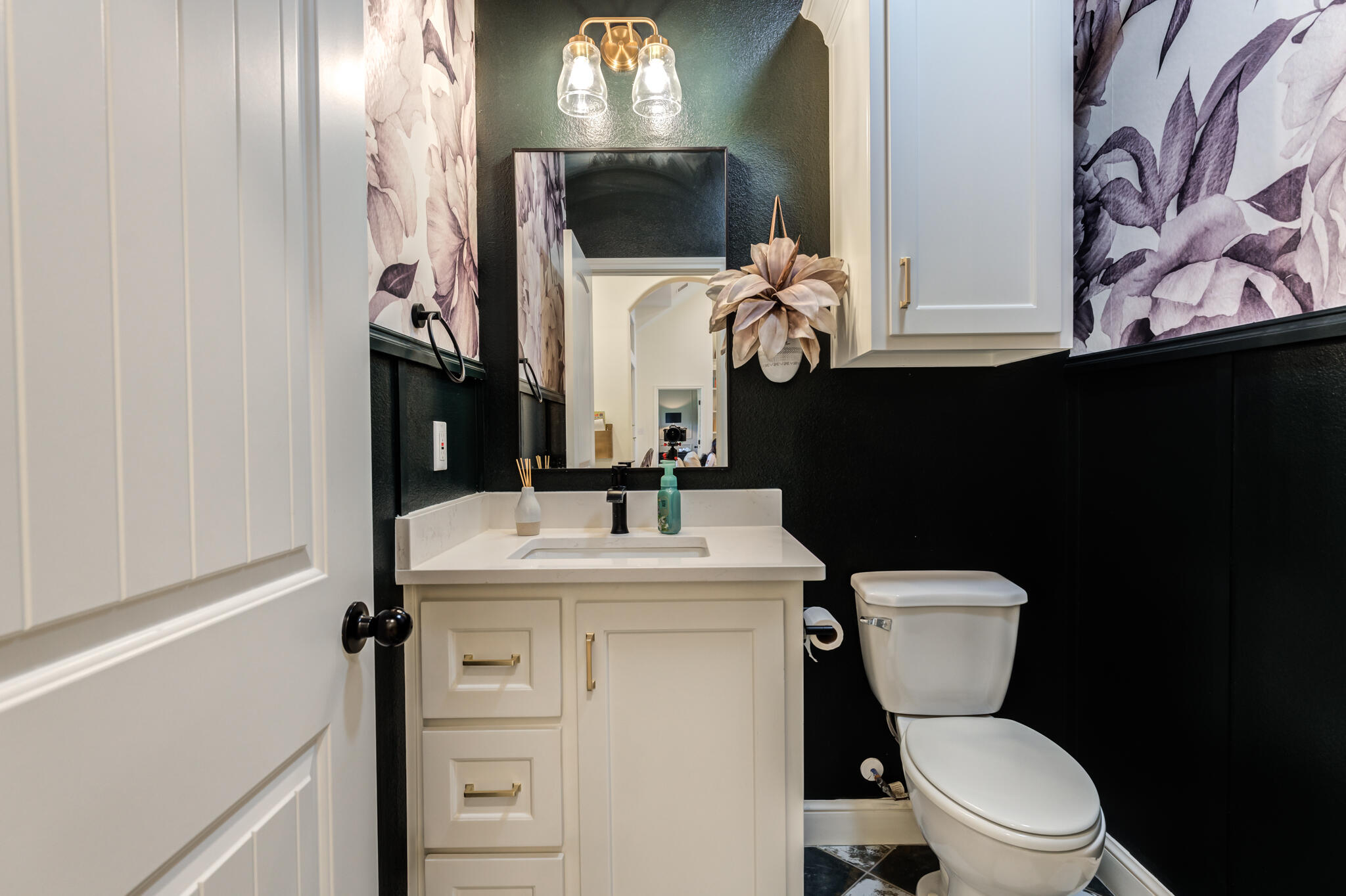 7819 55th Street Lubbock, TX 79407 - Photo 27 of 39 a bathroom with a toilet sink and mirror