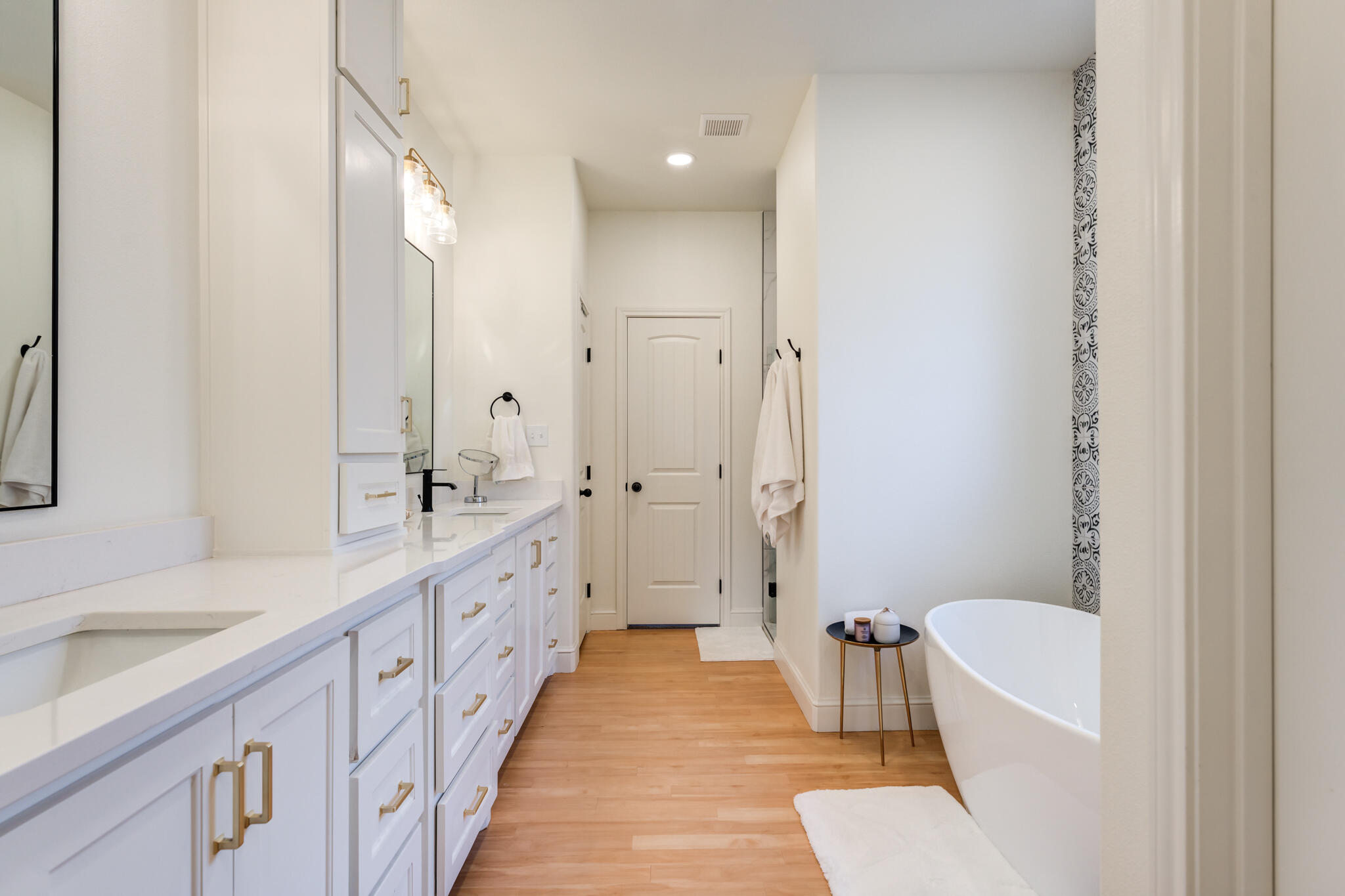 7819 55th Street Lubbock, TX 79407 - Photo 30 of 39 a spacious bathroom with a double vanity sink a toilet a mirror and shower