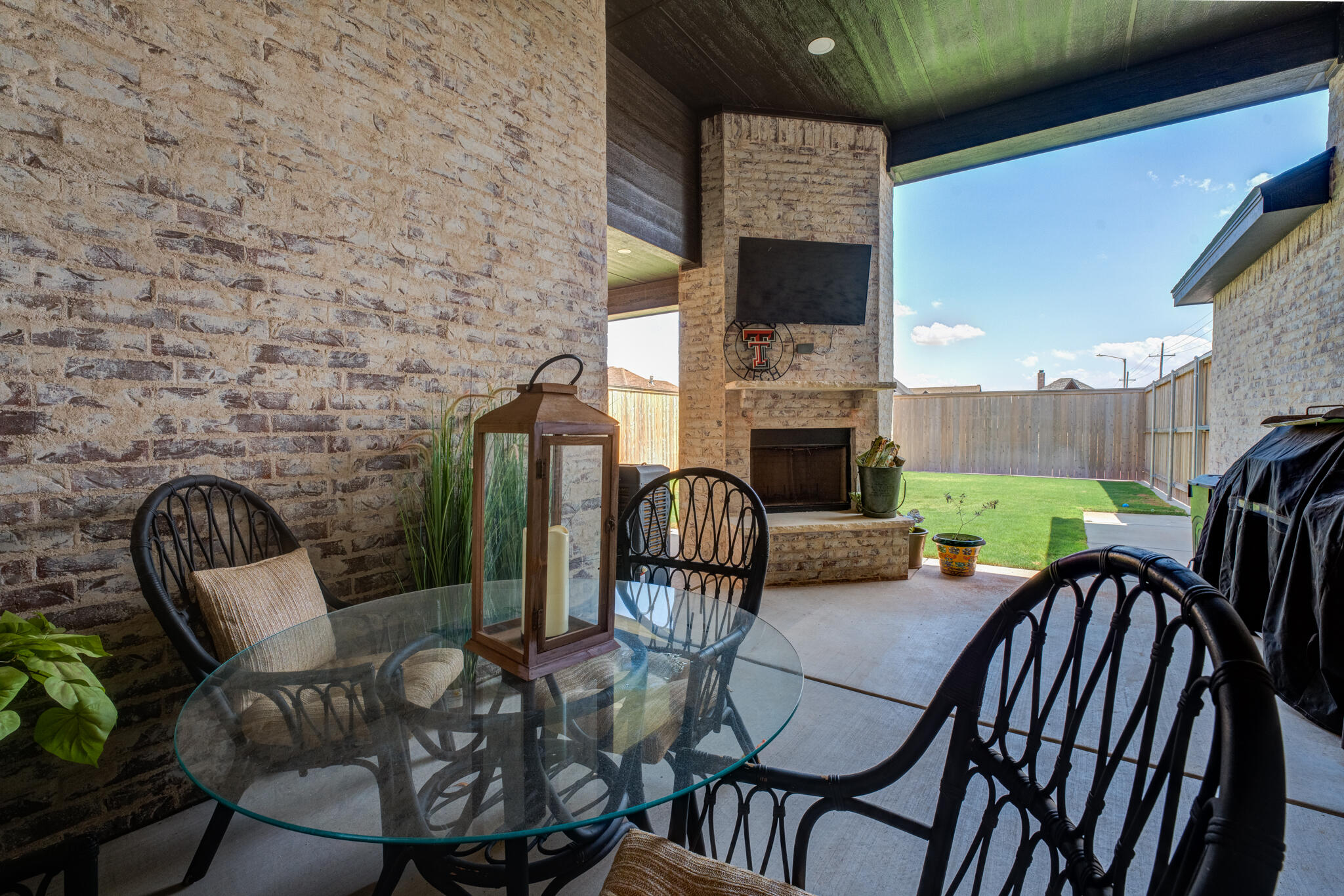 7819 55th Street Lubbock, TX 79407 - Photo 36 of 39 a view of a patio with a table chairs and a barbeque