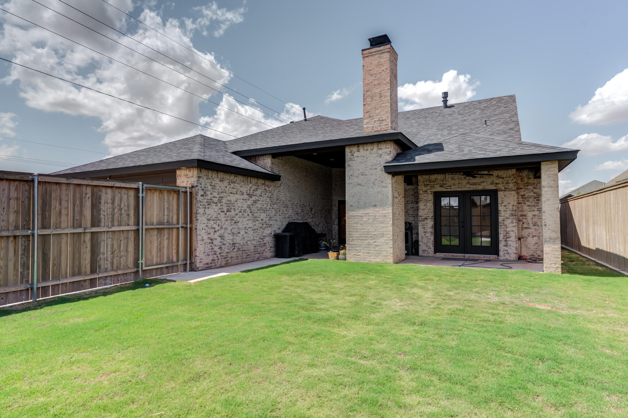 7819 55th Street Lubbock, TX 79407 - Photo 39 of 39 a view of an house with backyard and fireplace