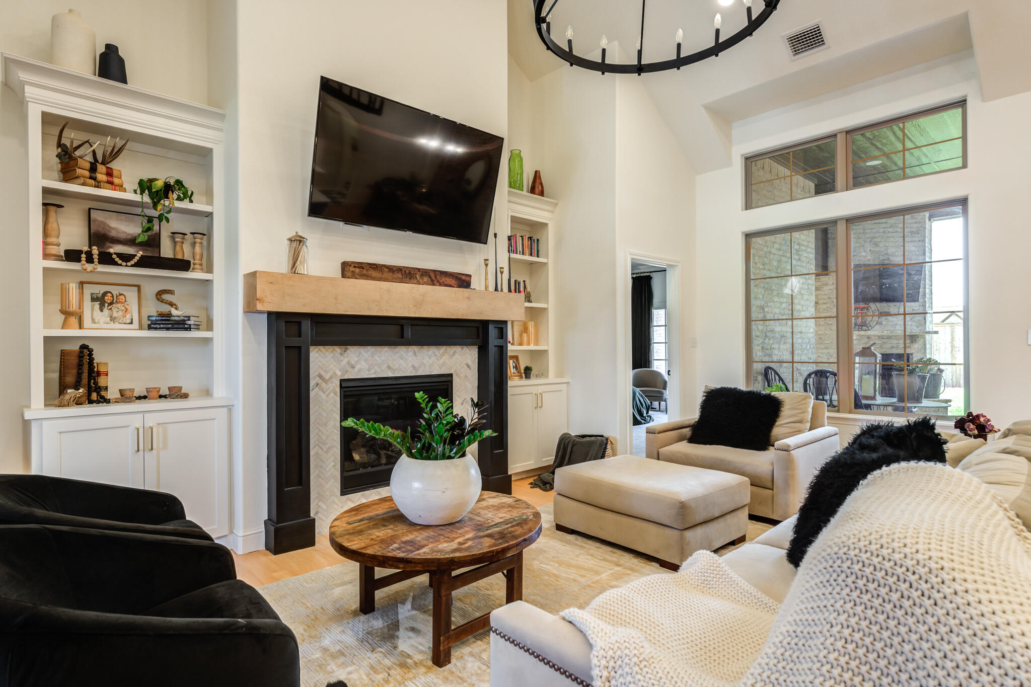 7819 55th Street Lubbock, TX 79407 - Photo 7 of 39 a living room with furniture a flat screen tv and a fireplace