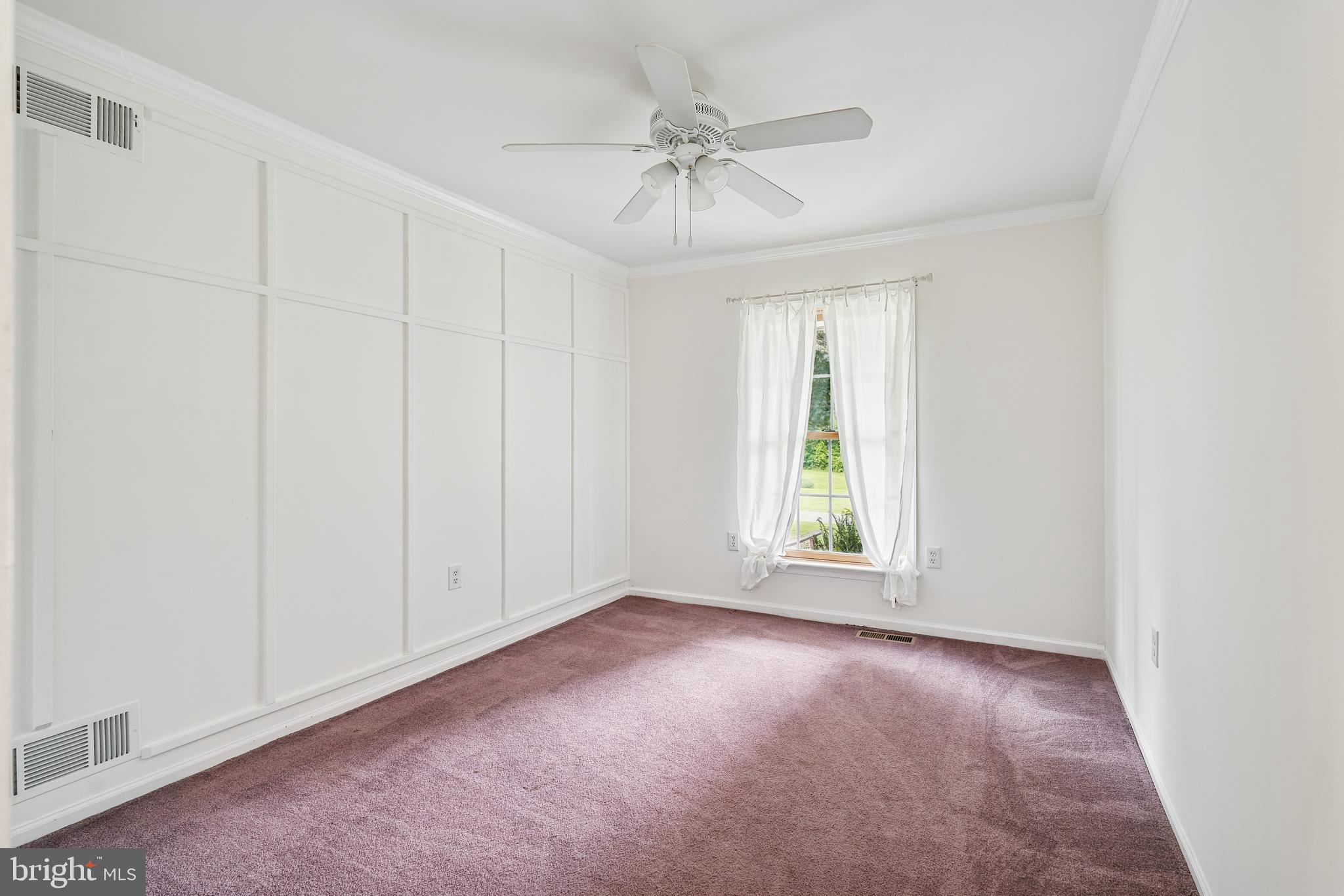410 Star Rte Road Elkton, MD 21921 - Photo 28 of 40 an empty room with a ceiling fan and a window