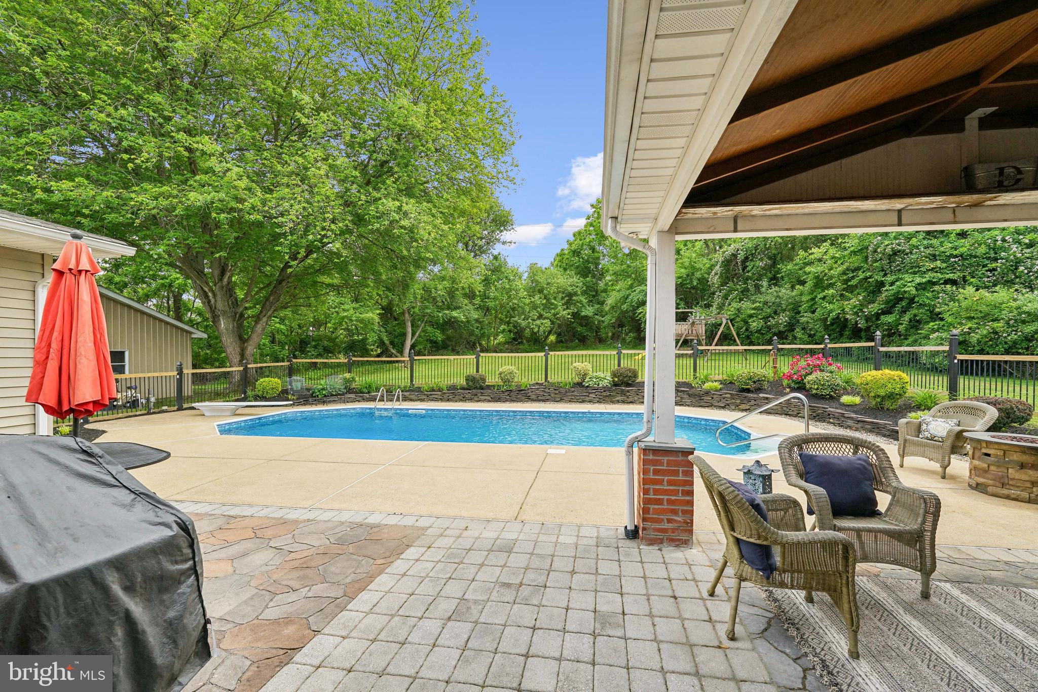 410 Star Rte Road Elkton, MD 21921 - Photo 37 of 40 a view of swimming pool with lounge chair and dinning table under an umbrella