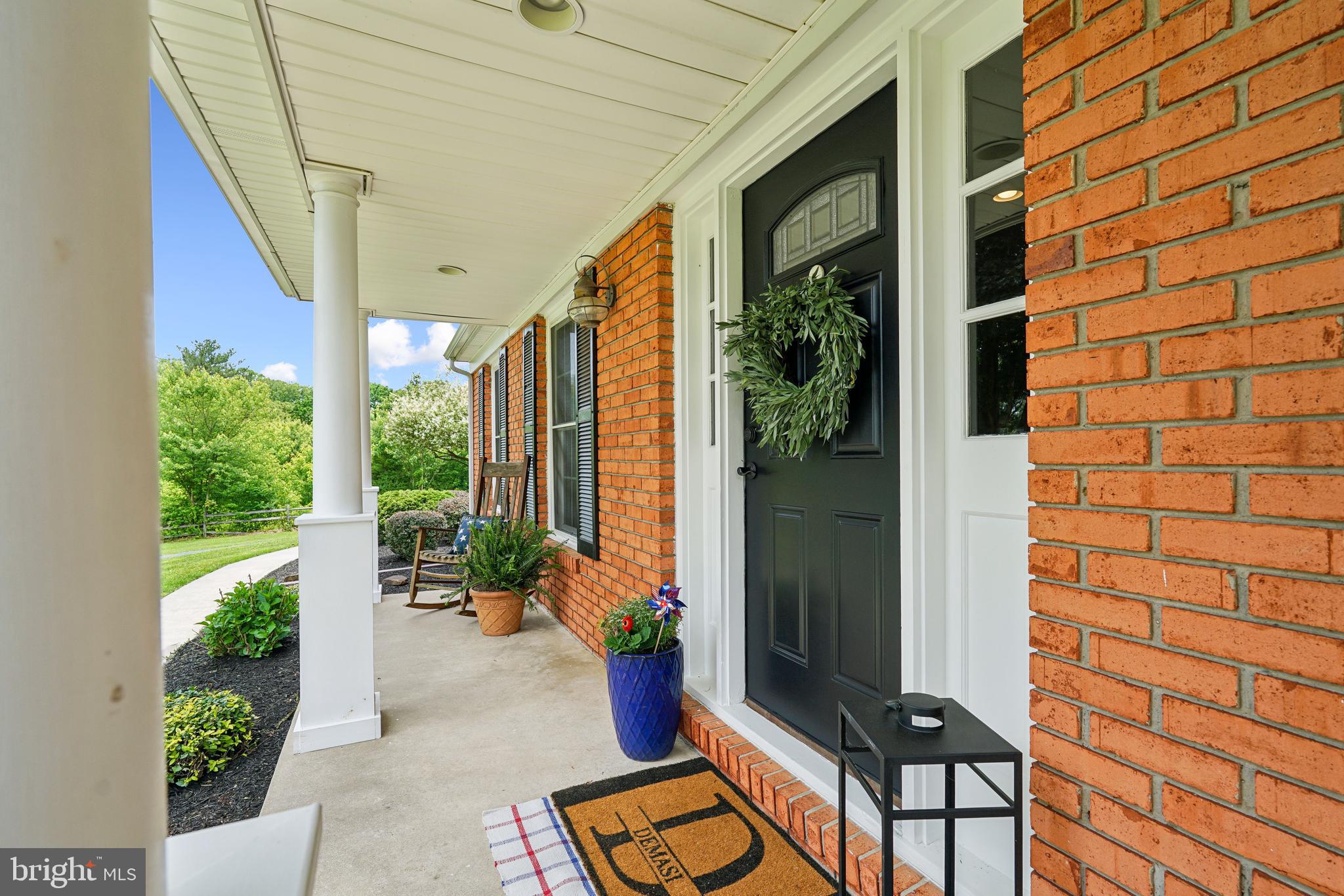 410 Star Rte Road Elkton, MD 21921 - Photo 6 of 40 a backyard of a house with potted plants and wooden bench