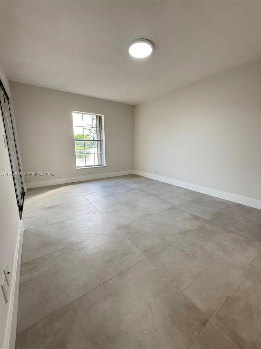 316 Cape Cod Circle, Unit B Lake Worth, FL 33467 - Photo 11 of 38 an empty room with windows