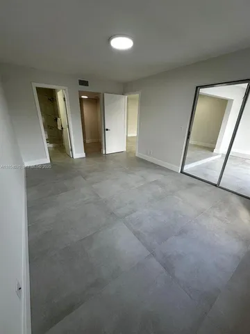 a bathroom with a sink mirror and toilet