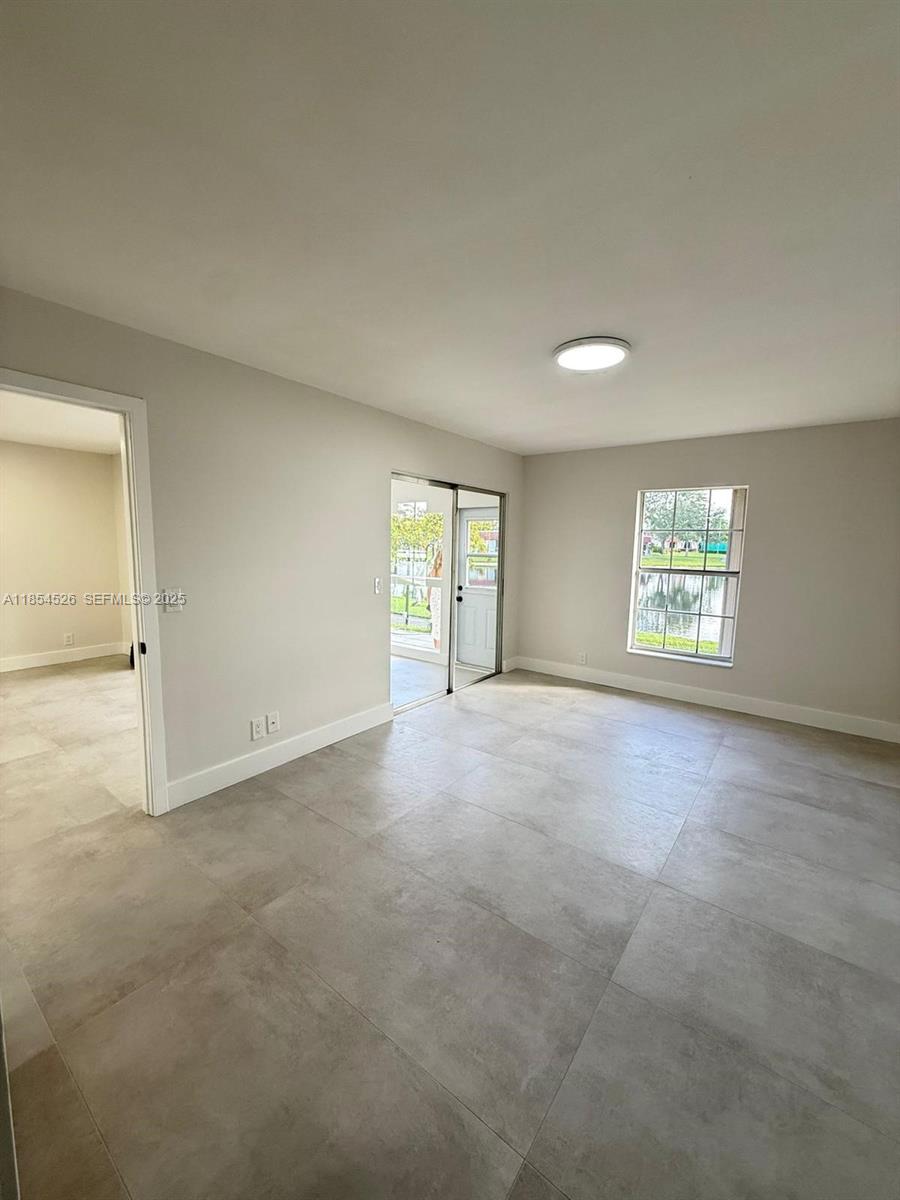 316 Cape Cod Circle, Unit B Lake Worth, FL 33467 - Photo 14 of 38 an empty room with windows