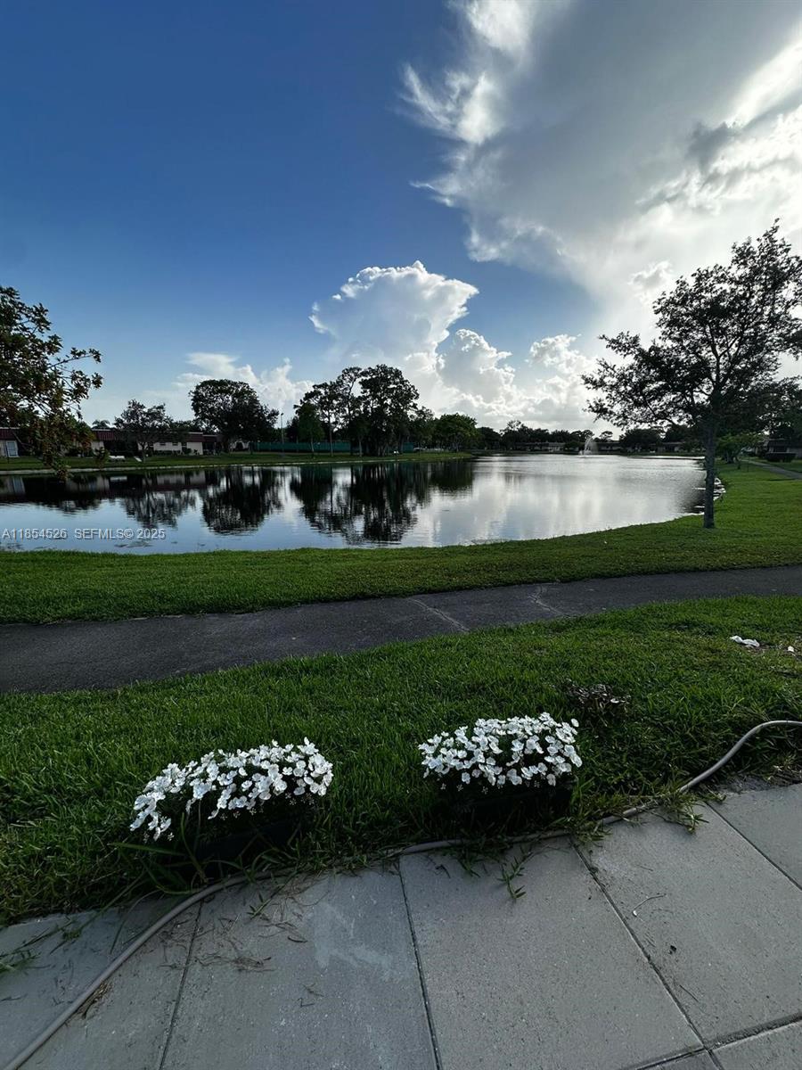 316 Cape Cod Circle, Unit B Lake Worth, FL 33467 - Photo 21 of 38 a view of a table and chairs in back yard