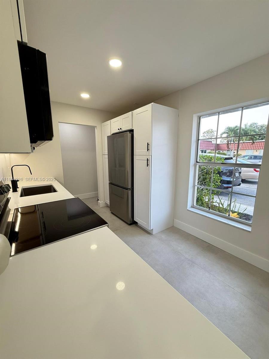 316 Cape Cod Circle, Unit B Lake Worth, FL 33467 - Photo 3 of 38 a bedroom with a bed and a flat screen tv