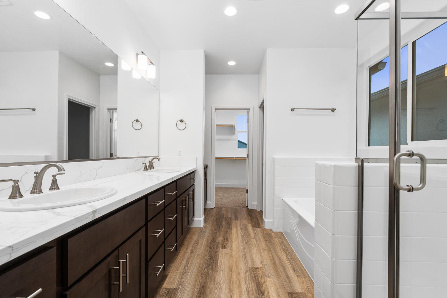 352 South Huckleberry Road Madera, CA 93636 - Photo 13 of 17 a spacious bathroom with a double vanity sink a mirror and shower