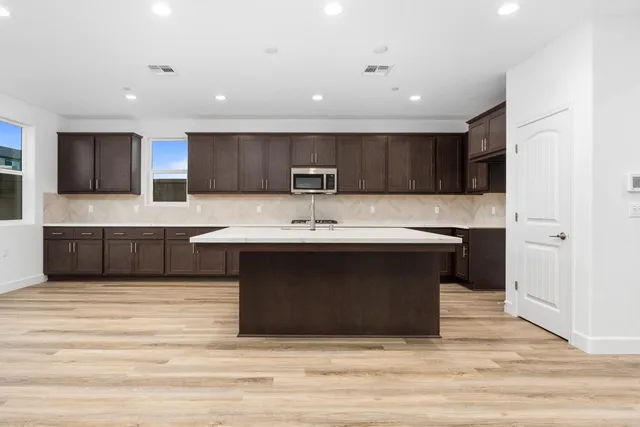 a kitchen with stainless steel appliances kitchen island a cabinets and a counter top space