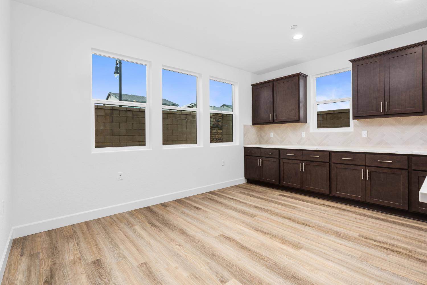 352 South Huckleberry Road Madera, CA 93636 - Photo 6 of 17 a kitchen with stainless steel appliances granite countertop a stove a sink and a microwave