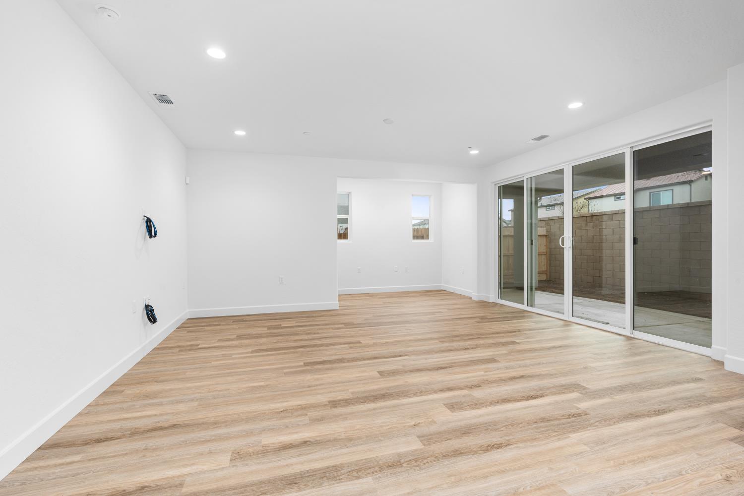 352 South Huckleberry Road Madera, CA 93636 - Photo 7 of 17 a view of an empty room with wooden floor and a window